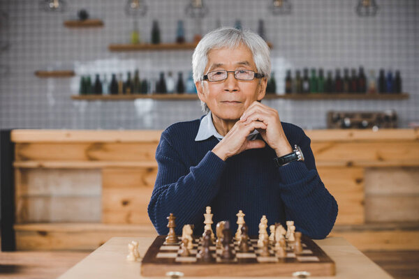 asian man with chess board