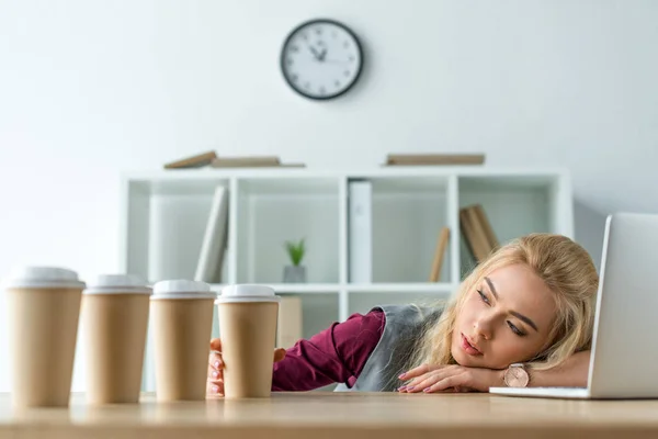 Tired businesswoman lying on table — Stock Photo, Image