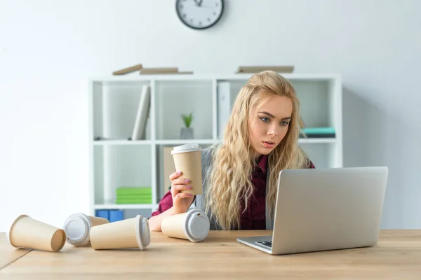 Tired businesswoman drinking lot of coffee — Stock Photo, Image