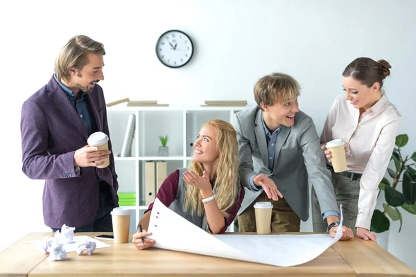 Colleagues talking and drinking coffee