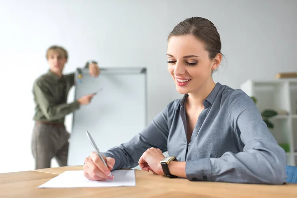 Business woman writing down something — стоковое фото