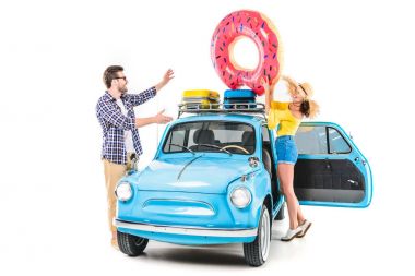 couple putting inflatable donut on car clipart