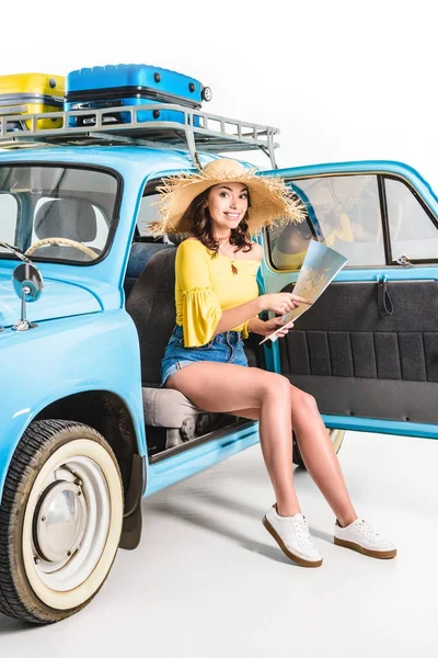 Woman sitting in car with map — Stock Photo, Image