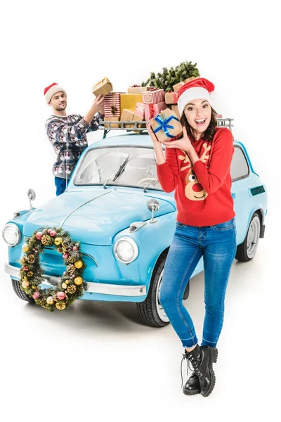 Pareja con regalos de Navidad en el techo del coche — Foto de Stock