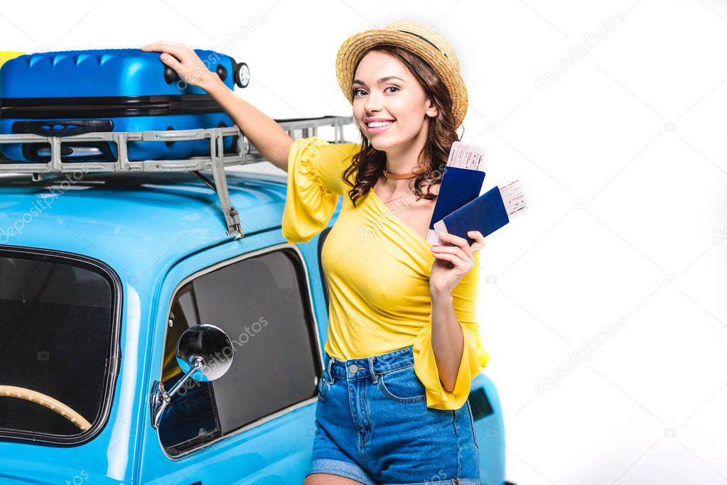 woman with tickets next to vintage car