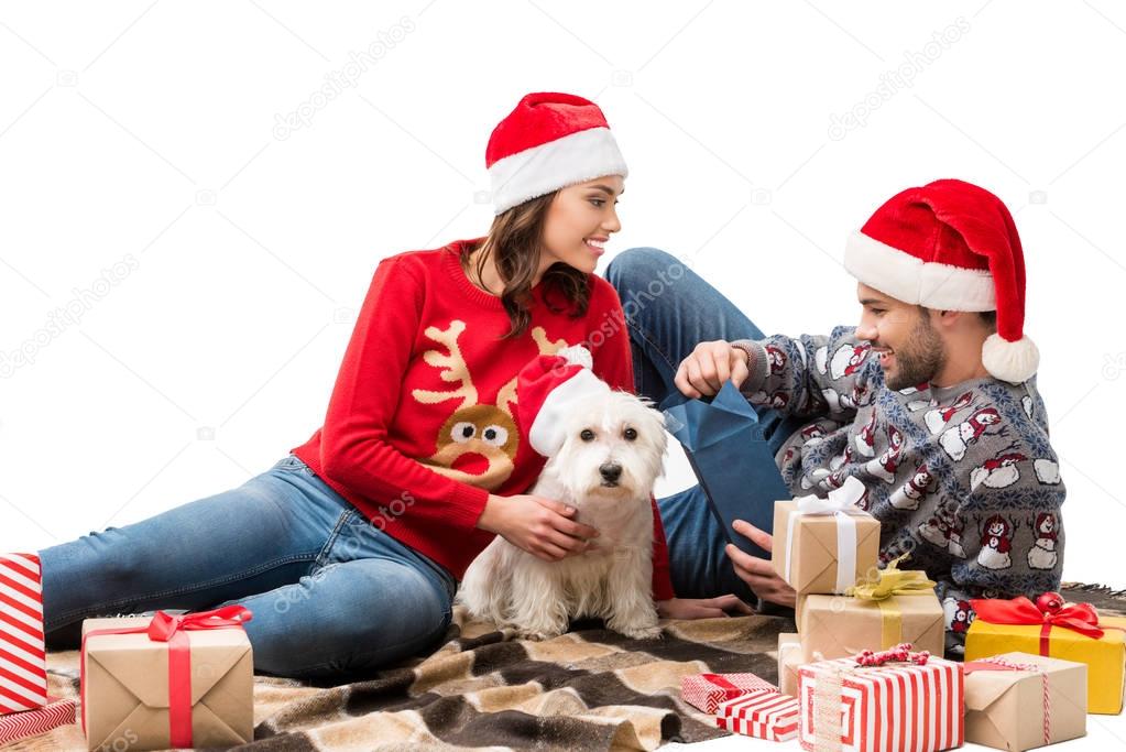 young couple with dog and christmas gifts