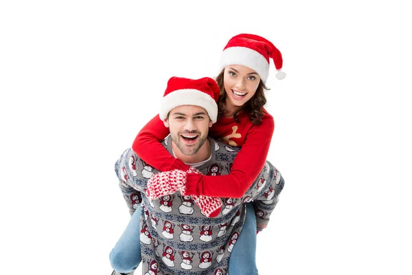 年轻的夫妇，在圣诞老人的帽子 — 图库照片