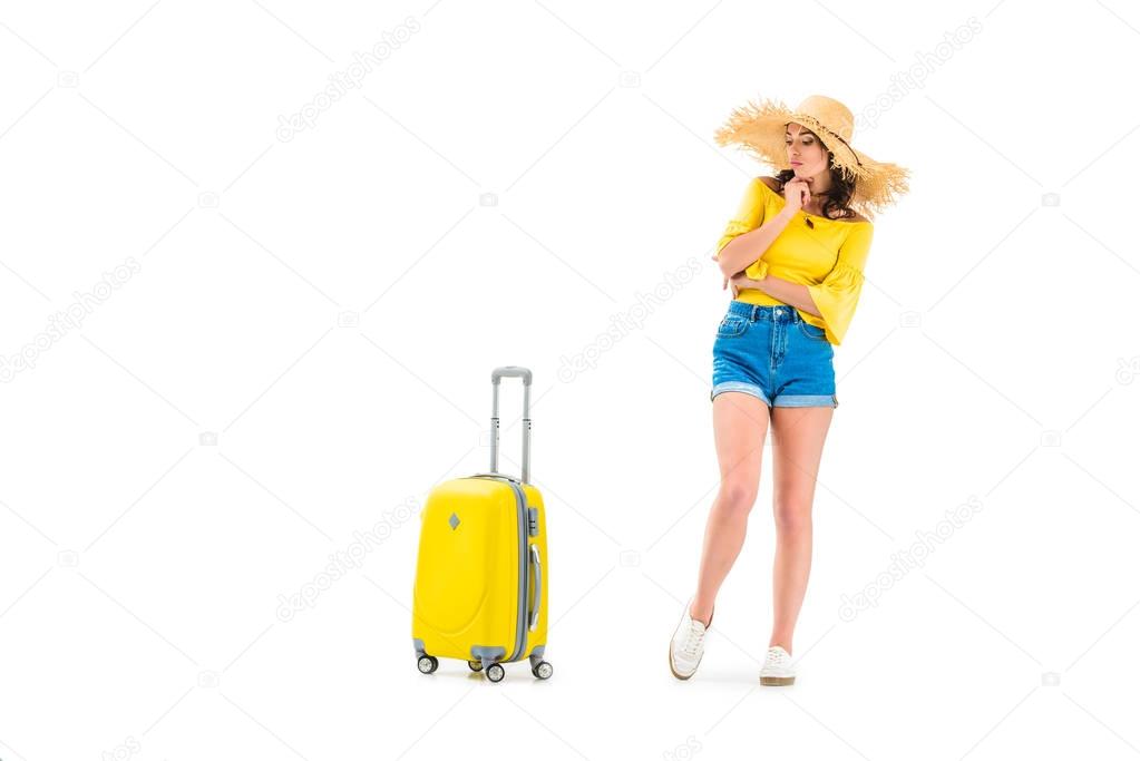 thoughtful woman looking at suitcase