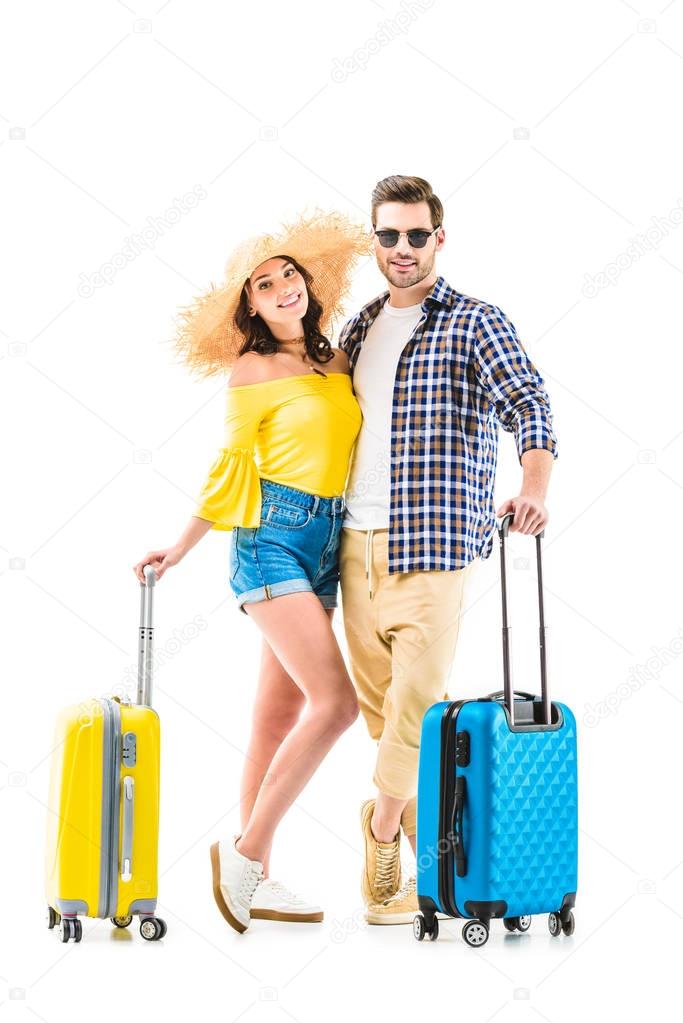 couple of tourists holding luggages