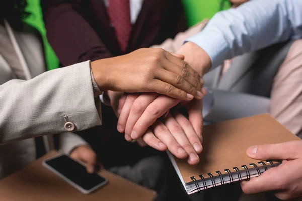 Cropped View Business Team Holding Hands Together Front Green Wall — Free Stock Photo