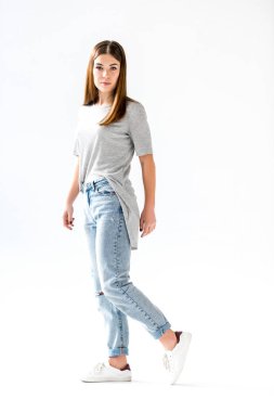 young stylish woman in jeans and grey shirt looking at camera,  isolated on white clipart