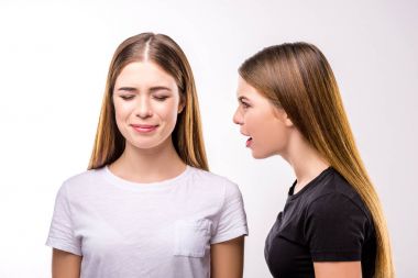 portrait of woman screaming at twin sister with eyes closed clipart