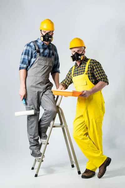 Trabajadores con rodillo de pintura - foto de stock