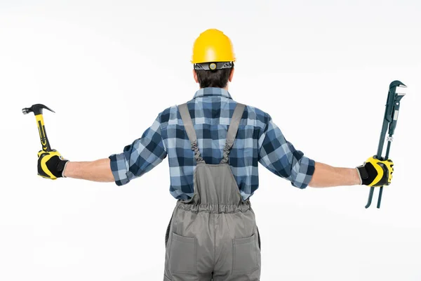 Workman holding hammer and pipe wrench — Stock Photo