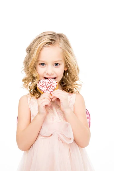 Girl holding heart shaped cookie — Stock Photo