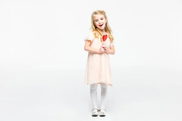 Girl with heart shaped lollipop — Stock Photo