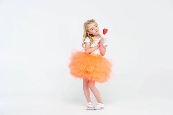 Girl with heart shaped lollipop — Stock Photo