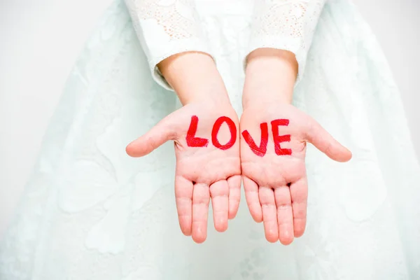 Word love written on palms — Stock Photo