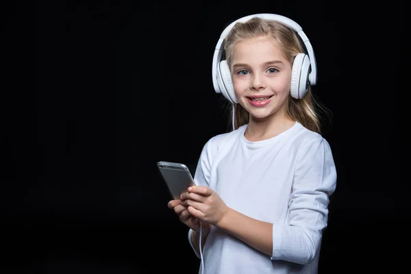 Little girl in headphones — Stock Photo