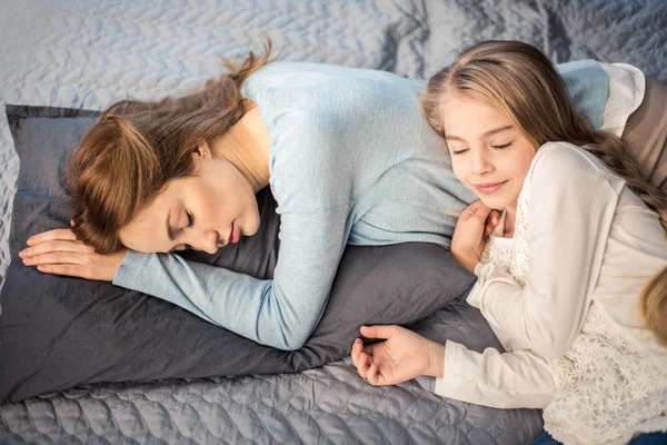 Madre e figlia sdraiate sul letto — Foto stock