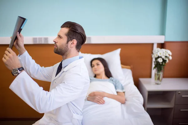 Doctor holding x-ray image — Stock Photo