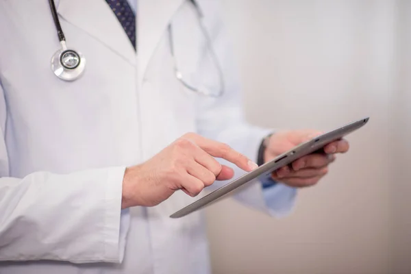 Doctor using digital tablet — Stock Photo