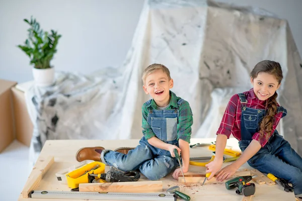 Kids sawing wooden plank — Stock Photo