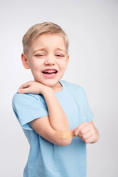 Little boy with patch on elbow — Stock Photo