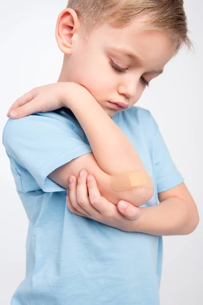 Little boy with patch on elbow — Stock Photo