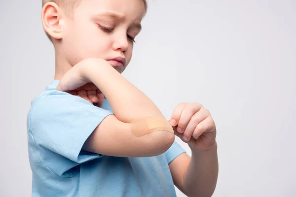 Little boy with patch on elbow — Stock Photo