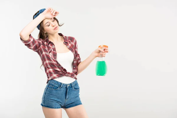 Young woman with spray bottle — Stock Photo