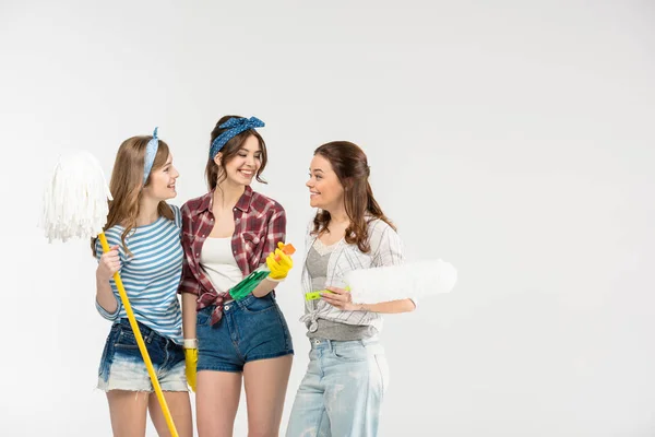 Young women with cleaning supplies — Stock Photo