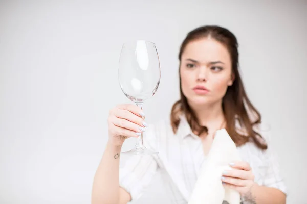 Woman cleaning wine glass — Stock Photo