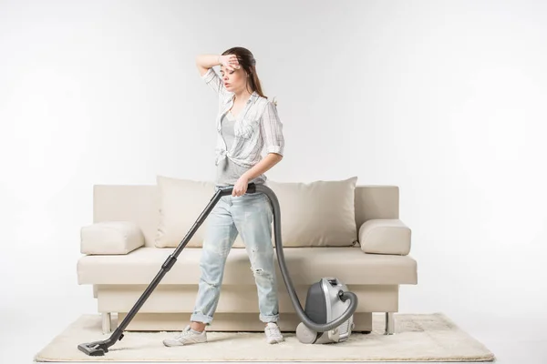 Woman vacuuming carpet — Stock Photo