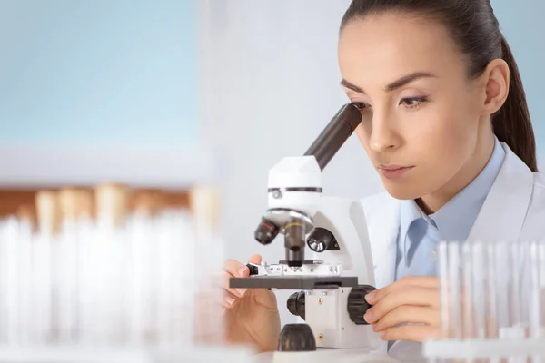 Scientist working with microscope — Stock Photo