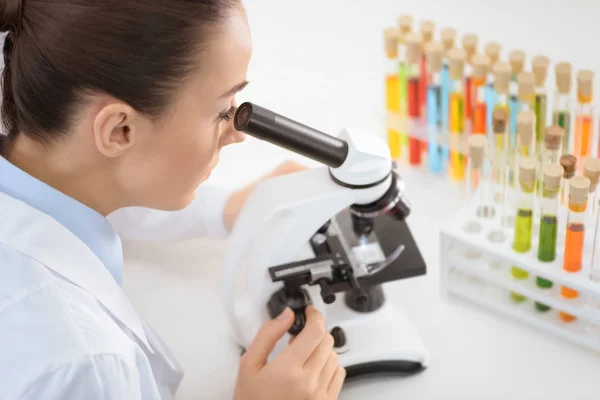 Scientist working with microscope — Stock Photo