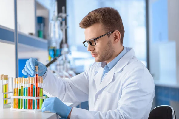 Scientist with test tubes — Stock Photo