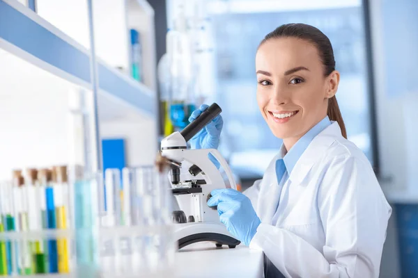 Scientist working with microscope — Stock Photo