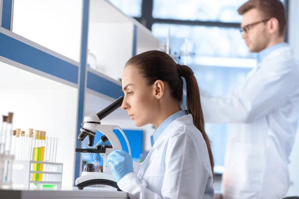 Scientist working with microscope — Stock Photo