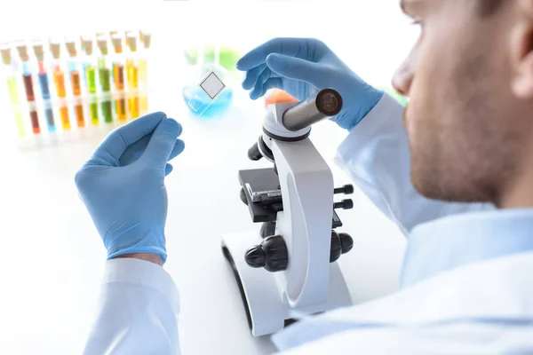 Scientist working with microscope — Stock Photo