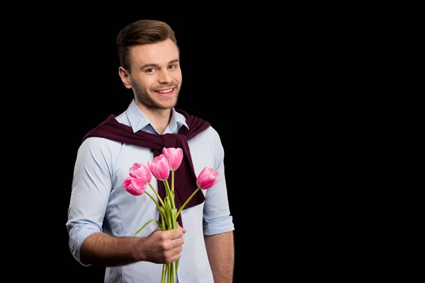 Человек держит тюльпаны — стоковое фото