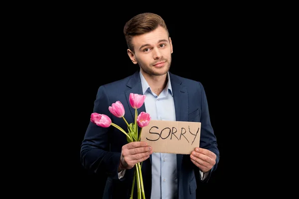 Homme avec des tulipes et signe désolé — Photo de stock