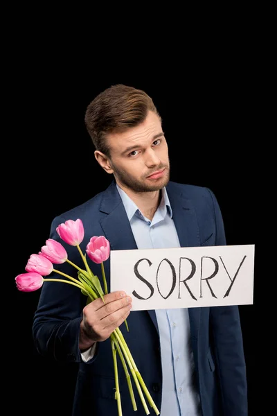 Hombre con tulipanes y señal triste - foto de stock