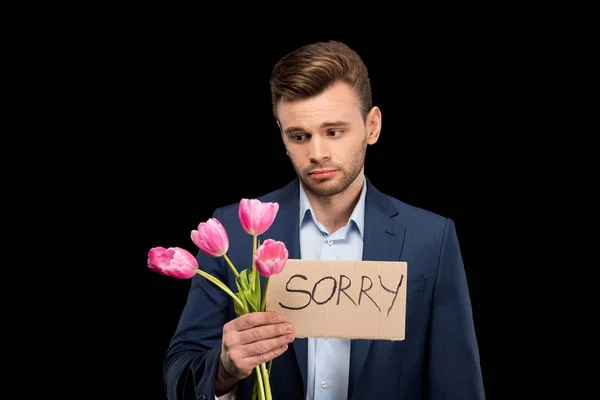 Homme avec des tulipes et signe désolé — Photo de stock