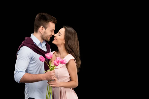 Couple in love with tulips — Stock Photo