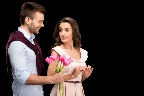 Couple in love with tulips — Stock Photo