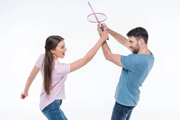 Couple with badminton rackets — Stock Photo