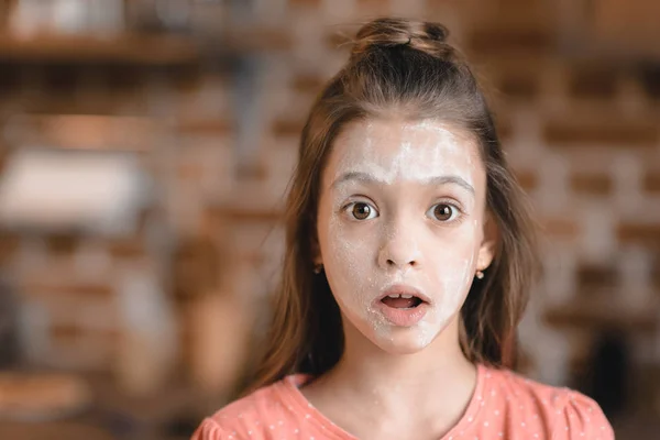 Girl with flour on face — Stock Photo