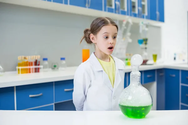 Girl scientist with lab tube — Stock Photo