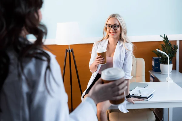 Beautiful doctors drinking coffee — Stock Photo